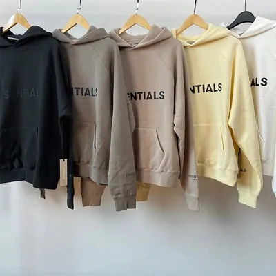 Five heavyweight hoodies on wooden hangers in oatmeal, grey and cream