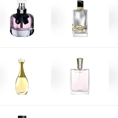 Four glass fragrance bottles on white, two upright and two squat, in pink, clear and amber