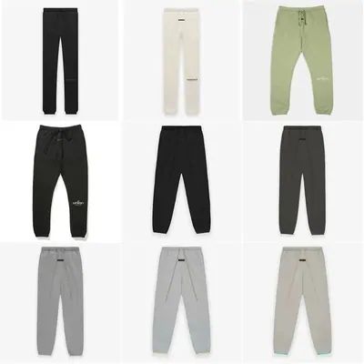 Nine pairs of jogging trousers on white in black, grey, cream and sage